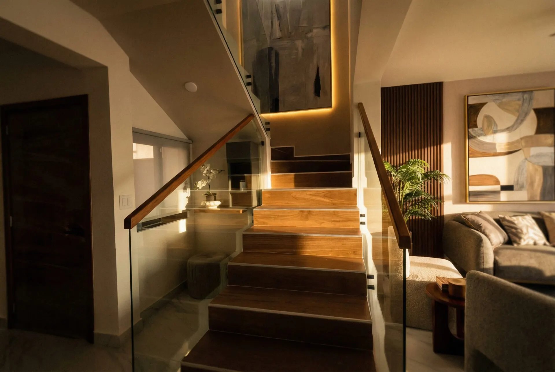 Escalera con pasamanos de vidrio y sala